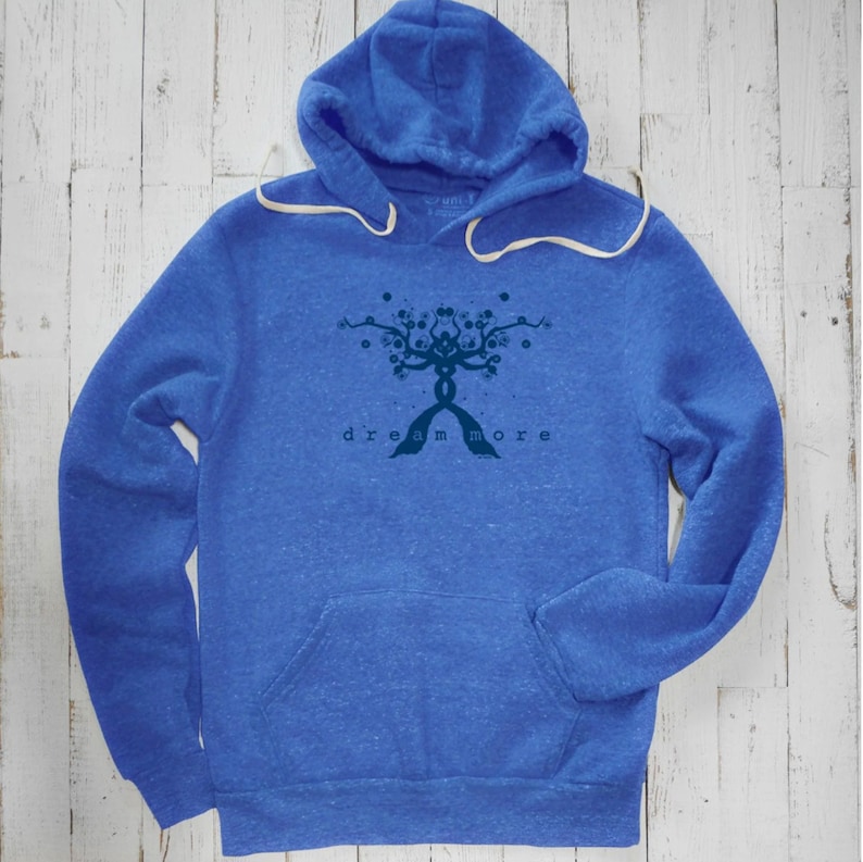 May include: A blue heather hoodie with a dark blue graphic of a tree with the text "dream more" underneath.