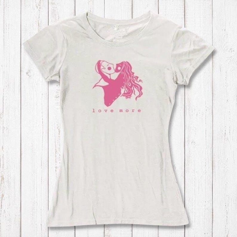 Ivory white Love More T-Shirt for women with pink heart graphic, crafted from bamboo & organic cotton. Romantic and sustainable gift idea.