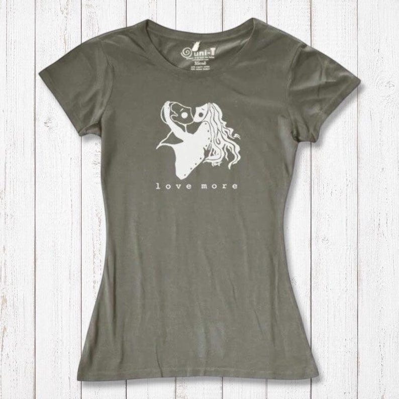Olive green Women's Love More T-Shirt in bamboo & organic cotton with white heart graphic. Eco-conscious romantic apparel gift.