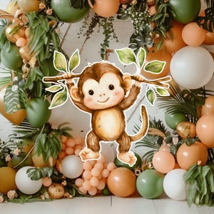 May include: A watercolor illustration of a brown monkey hanging from a branch with green leaves, centered against a backdrop of various sized balloons in shades of olive green, peach, and white, accented with green fern foliage and greenery.