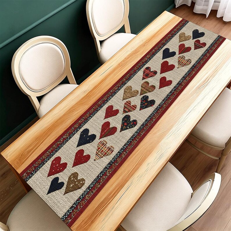 May include: A rectangular table runner featuring a beige backdrop and a repeating heart pattern in red, navy, and brown. The hearts display diverse patterns, including plaid and floral designs. The runner is edged with a red and navy pattern.