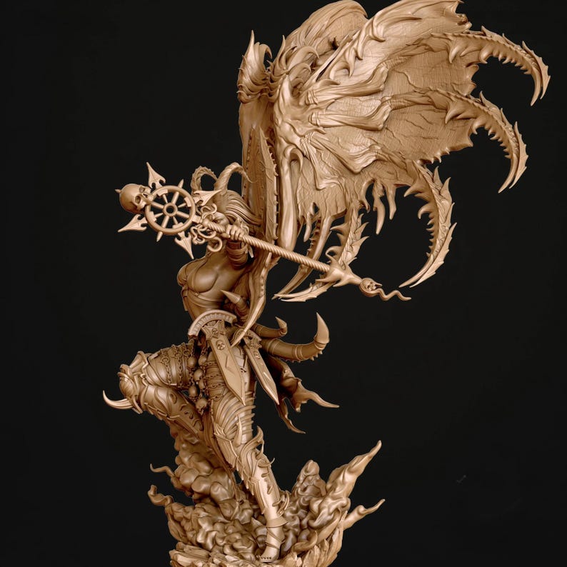 May include: A detailed sculpture of a female figure in a dynamic pose, holding a staff with a skull and starburst design. The figure has large, ornate wings and is clad in armour. The sculpture is a light brown colour.