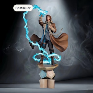 May include: A detailed figurine of a character in a brown coat, blue shirt, and black pants, holding a blue energy stream. The figurine stands on a stack of geometric shapes and open books. The word "Bestseller" is in a white oval.
