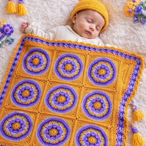 May include: A sleeping baby is nestled under a handmade, crocheted Persian Tile Baby Blanket. The blanket features a repeating pattern of orange and purple circles. The blanket is trimmed with a scalloped edge and tassels. The baby is wearing a yellow hat.