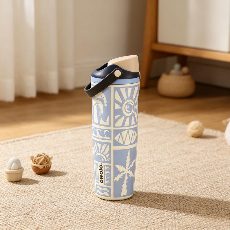 May include: A light blue insulated water bottle with a black handle and a beige lid. The bottle features a repeating pattern of suns, waves, and palm trees. The word "owolo." is printed on the side.