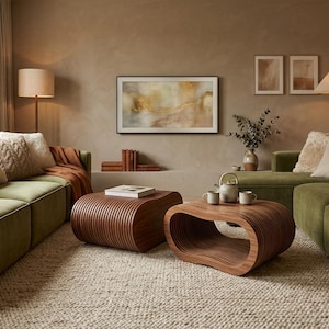 May include: A living room with olive green sofas, a large rug, and two wooden coffee tables. A framed artwork hangs above the coffee tables. Decorative pillows and a throw blanket add texture. Two lamps provide soft lighting.
