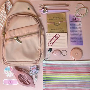 May include: A light pink sling backpack with a patterned strap, pens, a pencil case, stickers, a badge reel, a tape measure, and other accessories. The image includes a card that says "NURSE" and "A WISH FOR YOU".