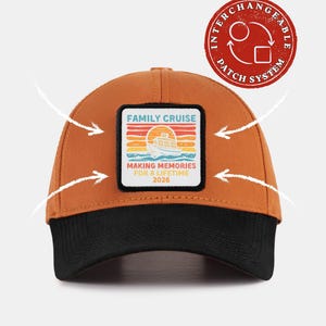 May include: A rust-coloured baseball cap with a black brim and a square patch on the front. The patch features a cruise ship graphic, a sunset, and the text: FAMILY CRUISE MAKING MEMORIES FOR A LIFETIME 2026. A red circular badge indicates an interchangeable patch system.