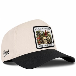 May include: A cream-coloured baseball cap with a black brim and a rectangular patch on the front. The patch features a human skull, various plants, and mushrooms with the text ALL PLANTS ARE EDIBLE SOME ONLY ONCE. The text Black Börk is on the side.