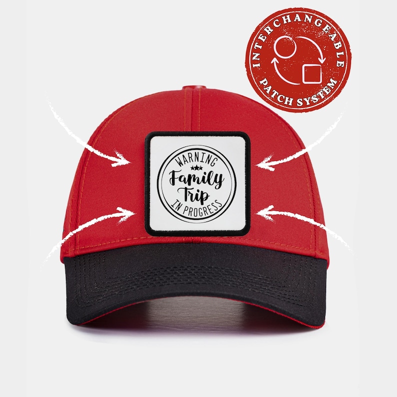 May include: A red baseball cap with a black brim and a square white patch on the front. The patch features a circular black graphic with the text "WARNING Family Trip IN PROGRESS". A red circular badge in the corner reads "INTERCHANGEABLE PATCH SYSTEM".