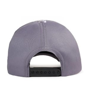 May include: A solid grey baseball cap featuring a structured crown with a central top button and a black plastic snapback closure at the rear. The cap is constructed from a smooth fabric with visible stitching along the panels and a curved opening.