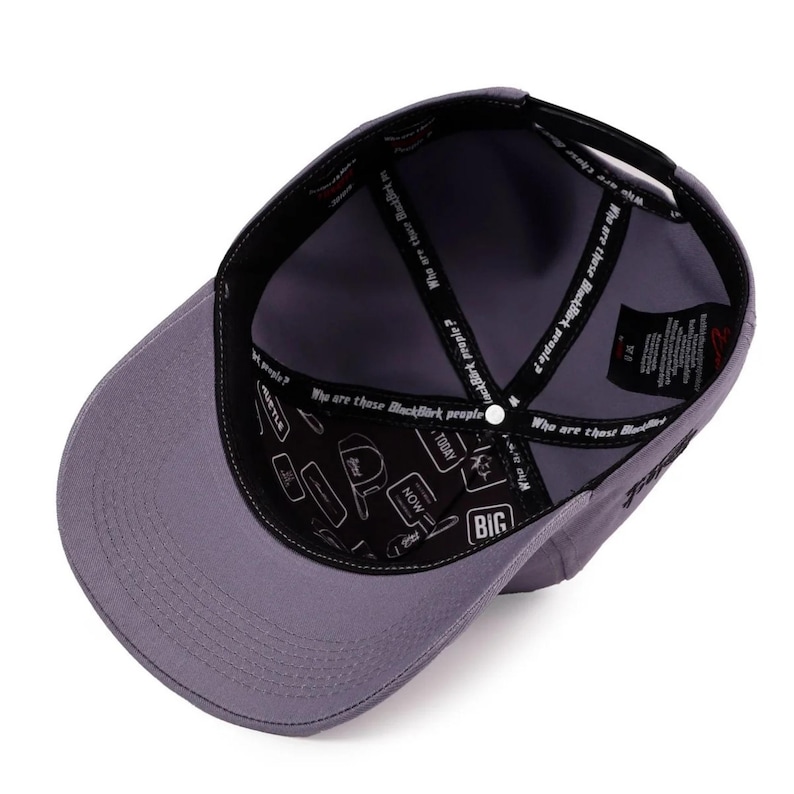 May include: A grey baseball cap shown from an interior perspective. The inner lining features black fabric tape printed with the text "Who are those BlackBirk people?" and a pattern of various rectangular icons containing words like "BIG" and "NOW".