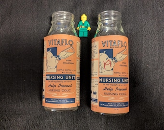 2 baby nursing glass bottles with Labels 1950
