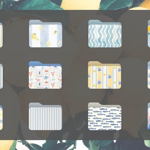 May include: A collection of twelve decorative folder icons with various patterns and designs. The folders feature stripes, lemons, bows, fish, and floral motifs in shades of blue, yellow, and white, set against a dark gray background.
