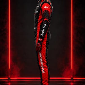 May include: A black and red racing suit featuring the text RACEWEAR printed vertically along the sleeve and leg. The suit includes a high collar, long sleeves, and matching black and red racing shoes with the letters RN visible on the side.
