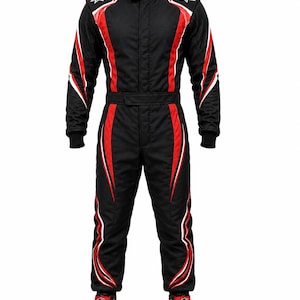 May include: A black racing suit featuring red and white vertical accents along the torso, arms, and legs. The suit has a high collar, long sleeves with ribbed cuffs, and white Alpinestars logos on the shoulders. Matching black and red racing shoes.