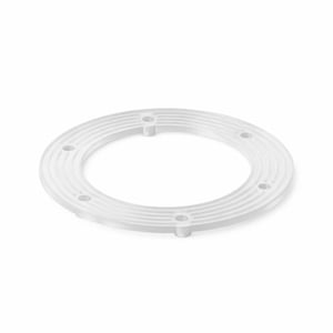May include: A circular, translucent white plastic ring featuring a series of concentric grooved lines on its top surface. The ring includes four evenly spaced, small cylindrical mounting holes positioned along its flat, circular frame.