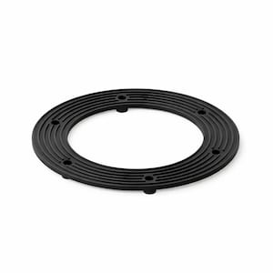 May include: A circular black ring-shaped component featuring a series of concentric grooved lines on its top surface. The object includes four evenly spaced circular holes and small protruding feet along its outer edge.
