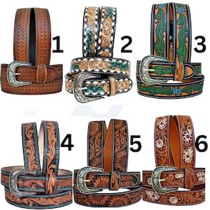 May include: A collection of six leather belts with intricate floral and geometric designs. The belts feature silver-toned buckles and are in various shades of brown, with accents of green, blue, and white. The belts are suitable for casual wear.