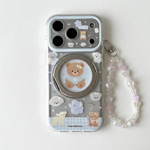 May include: A clear smartphone case featuring a circular metal ring stand and a beaded wrist strap. The case is decorated with various animal stickers including bears, an elephant, and a lamb, with the text Cream Doll Party at the bottom.