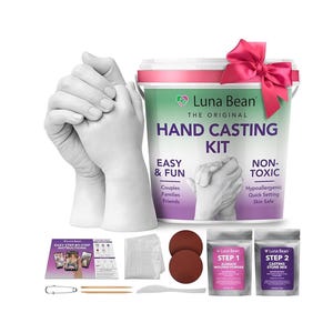 May include: A hand casting kit with the text "Luna Bean Hand Casting Kit". The kit includes a bucket, instructions, molding powder, casting stone mix, and other accessories. A pink bow adorns the bucket. The kit is designed for couples, families, and friends.
