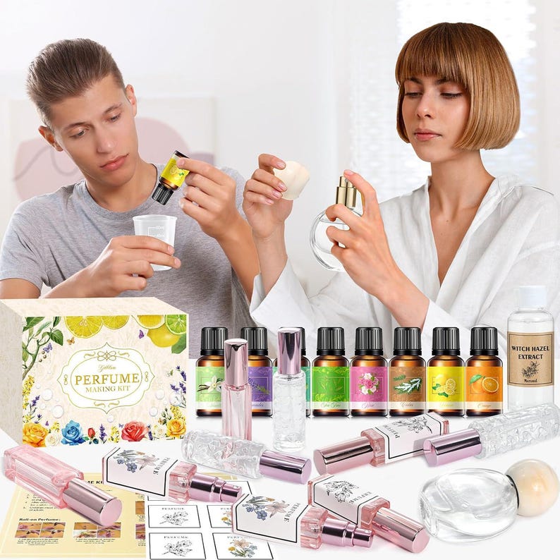 May include: A perfume making kit featuring a box labeled Perfume Making Kit, multiple small amber glass essential oil bottles with colorful labels, several clear glass spray bottles with pink caps, and a bottle of witch hazel extract.