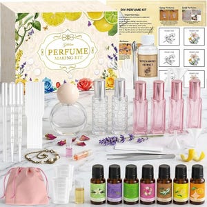 May include: A DIY perfume making kit featuring a large box with floral illustrations, a bottle of witch hazel extract, seven essential oil vials, four pink glass spray bottles, two clear glass spray bottles, a round perfume bottle, pipettes, and tools.