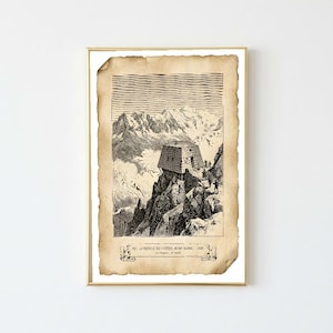 May include: A framed print on aged, tan paper featuring a black and white ink illustration of a mountain refuge on a rocky peak. The text at the bottom reads VUE DU REFUGE DU GOÛTER, MONT BLANC - 1887. The print is enclosed in a thin gold frame.