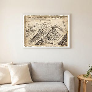 May include: A framed vintage-style map titled Carte de l'Ascension par le Gouter Mont Blanc France, featuring a detailed black and white topographical illustration of the mountain range with labeled peaks, glaciers, and a compass rose.