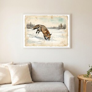 May include: A framed horizontal wall art print featuring a watercolor illustration of a brown fox pouncing into deep white snow. The background depicts a winter landscape with distant pine trees under a pale sky, all set on aged, textured paper.