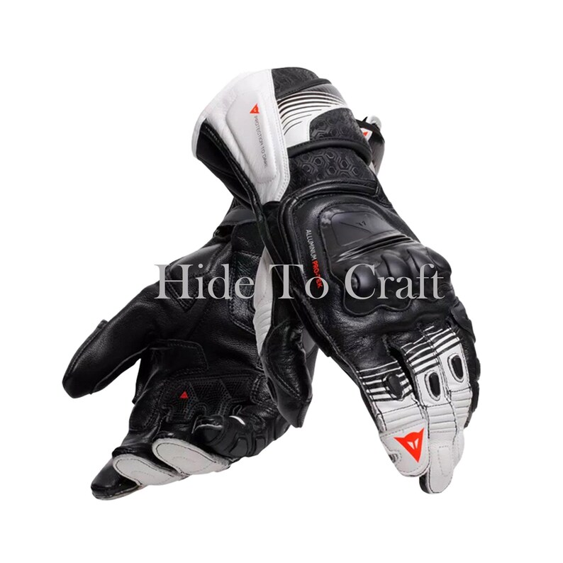 May include: Black and white motorcycle gloves with reinforced knuckles and palm. The gloves feature a combination of leather and synthetic materials, with white accents and the text "Hide To Craft".