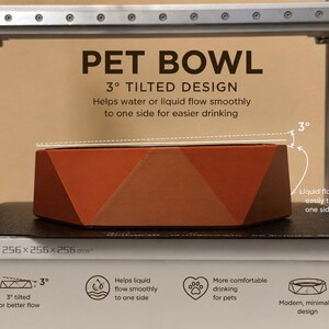 May include: An orange geometric pet bowl with a 3-degree tilt, designed to aid liquid flow. The image text reads "PET BOWL" and details the bowl's features, including easier drinking and a modern, minimalist design.