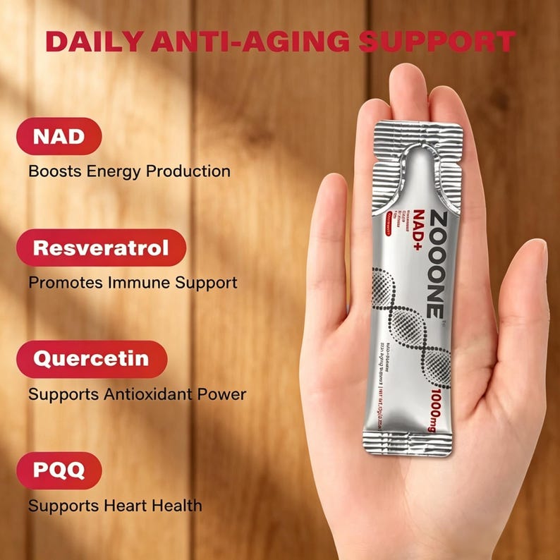 May include: A silver packet of ZOOONE NAD+ 1000mg supplement is held in a hand. The packet has the words "Daily Anti-Aging Support" at the top. The image also lists the benefits of NAD, Resveratrol, Quercetin, and PQQ.