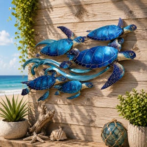 May include: A wall-mounted metal art piece featuring four blue sea turtles swimming amidst stylized waves. The turtles exhibit gradient shades of blue with intricate dark blue detailing on their shells and flippers, arranged in a dynamic formation.