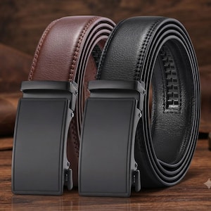 May include: Two belts, one in brown and one in black, each featuring a smooth, rectangular matte black buckle. The belts have a textured surface with visible stitching along the edges and a ratcheting track mechanism on the inner side of the strap.