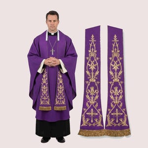May include: A purple liturgical vestment set, including a chasuble and two stoles. The chasuble features white trim and gold embroidered designs. The stoles have gold fringe and matching embroidery. The set is worn by a person.