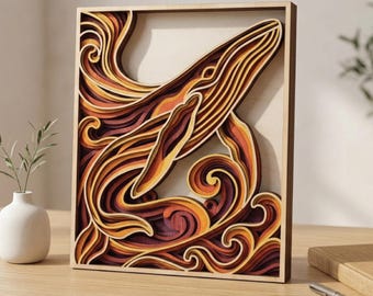 May include: A multi-layered wooden artwork of a whale swimming in stylized waves. The piece uses warm colours like orange, brown, and red, creating a textured effect. The whale is the focal point, with detailed lines and curves. The artwork is approximately 30 cm x 40 cm.
