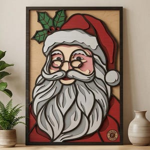 May include: A multi-layered wooden wall art piece depicting Santa Claus with a long gray beard, wearing a red hat with white trim and a sprig of green holly with red berries. The artwork features a dark frame and a circular logo in the corner.