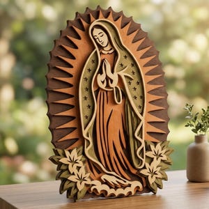 May include: A layered wooden wall art piece depicting the Virgin of Guadalupe with a sunburst background. The figure wears a robe with star patterns, hands clasped in prayer, surrounded by carved floral accents in shades of brown and tan.
