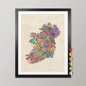 The image is a framed artwork depicting a colorful map of Ireland, with the country's name written in various colors across the map.