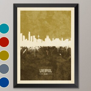 May include: A framed print of the Liverpool skyline in white against a brown and gold background. The text "LIVERPOOL" and "ENGLAND" is at the bottom of the print.