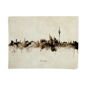 the skyline of Berlin, featuring the spire of the Berliner Fernsehturm, a prominent landmark in the city.