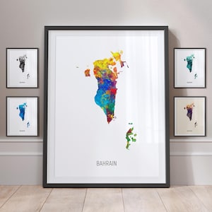 May include: A colorful watercolor map of Bahrain, with the country name printed below. The map is framed in black and displayed on a wall with other framed maps.