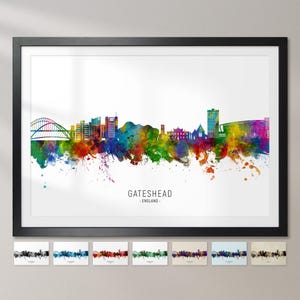 May include: A watercolour cityscape of Gateshead, England. The skyline is depicted in vibrant colours with splashes of paint. The city's iconic Tyne Bridge is visible in the background.