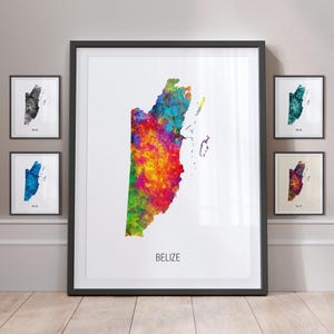 May include: A colorful watercolor map of Belize, with the country name printed below. The map is framed in black and displayed on a wall with other framed maps.