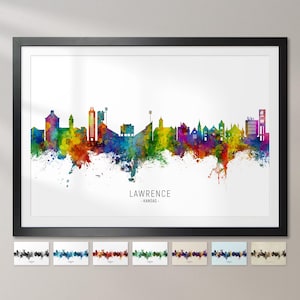 May include: A framed print featuring a colorful watercolor skyline of Lawrence, Kansas. The artwork showcases a vibrant spectrum of colors, including blues, greens, yellows, and purples. The city's name is printed in black below the skyline. Several smaller prints are displayed below the main image.