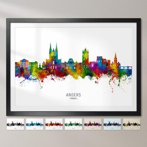 May include: A colourful watercolour cityscape of Angers, France. The skyline features a tall church with two spires and other buildings in the background. The city name is written below the skyline.