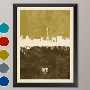 May include: A watercolor-style illustration of the Paris skyline in white against a brown and gold background. The Eiffel Tower is the most prominent feature, with other landmarks like the Arc de Triomphe and Notre Dame Cathedral visible. The text "PARIS - FRANCE" is at the bottom of the image.
