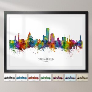 Pode incluir: Uma ilustração colorida em aquarela do horizonte de Springfield, Illinois. O horizonte apresenta o edifício do Capitólio do estado e outros edifícios proeminentes. A ilustração é emoldurada em preto e colocada sobre um fundo branco.