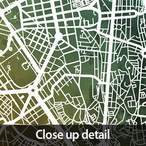 May include: A detailed map of a city with white lines on a green and yellow watercolor background. The map shows streets, roads, and waterways.